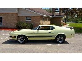 1994 Ford Bronco - This 1971 Ford Mustang Mach 1 is seen in a parking lot next to a building.