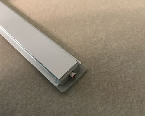 1995 Ford Bronco - A white trim piece with visible wires is shown against a neutral background.