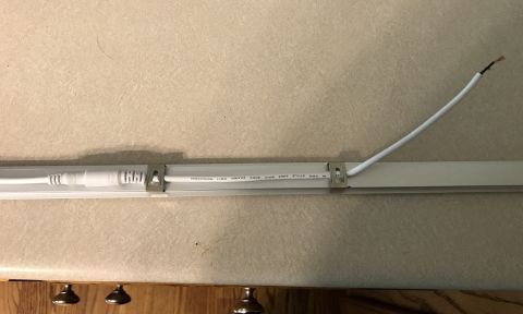 1995 Ford Bronco - LED light strip with visible wiring and connector, mounted on a surface.