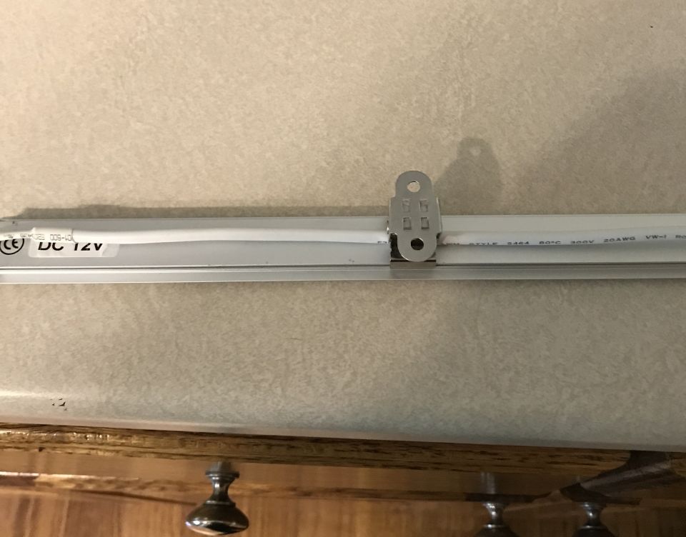 LED light strip with "DC 12V" text, mounted with a metal bracket