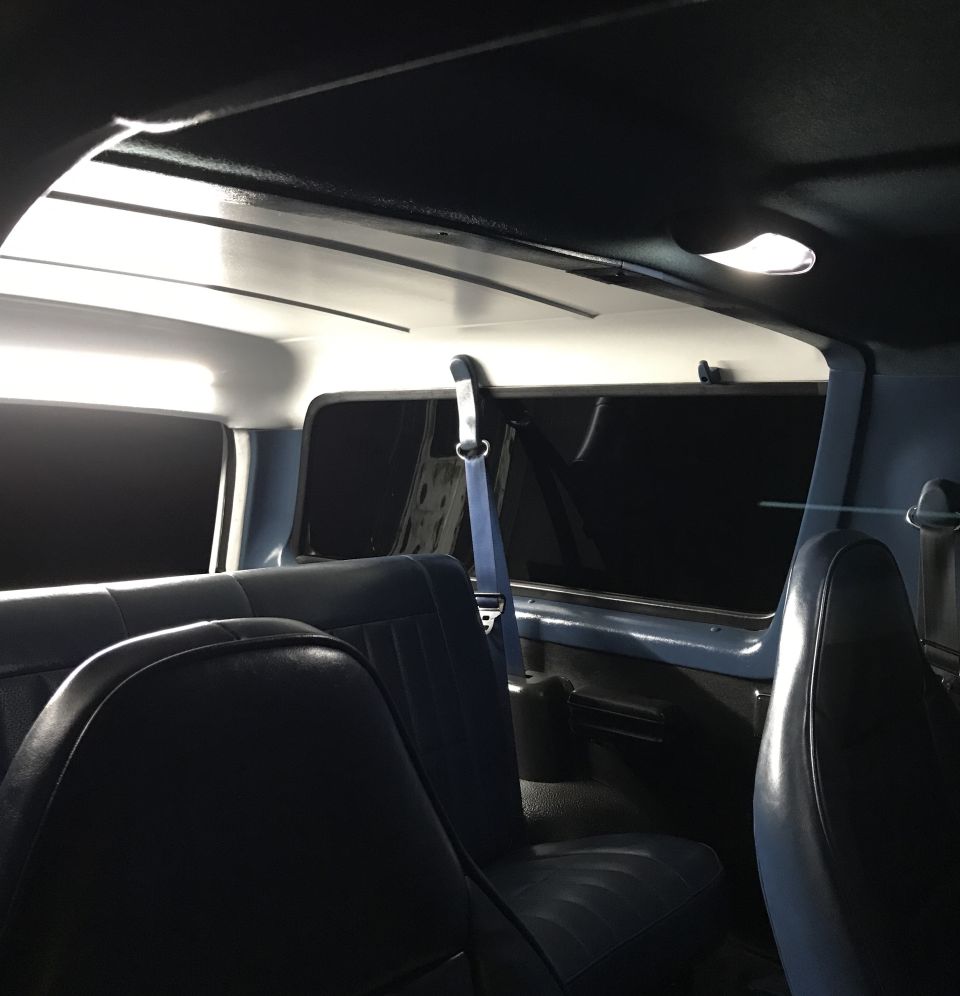Interior view of a vehicle showing blue seats and headliner