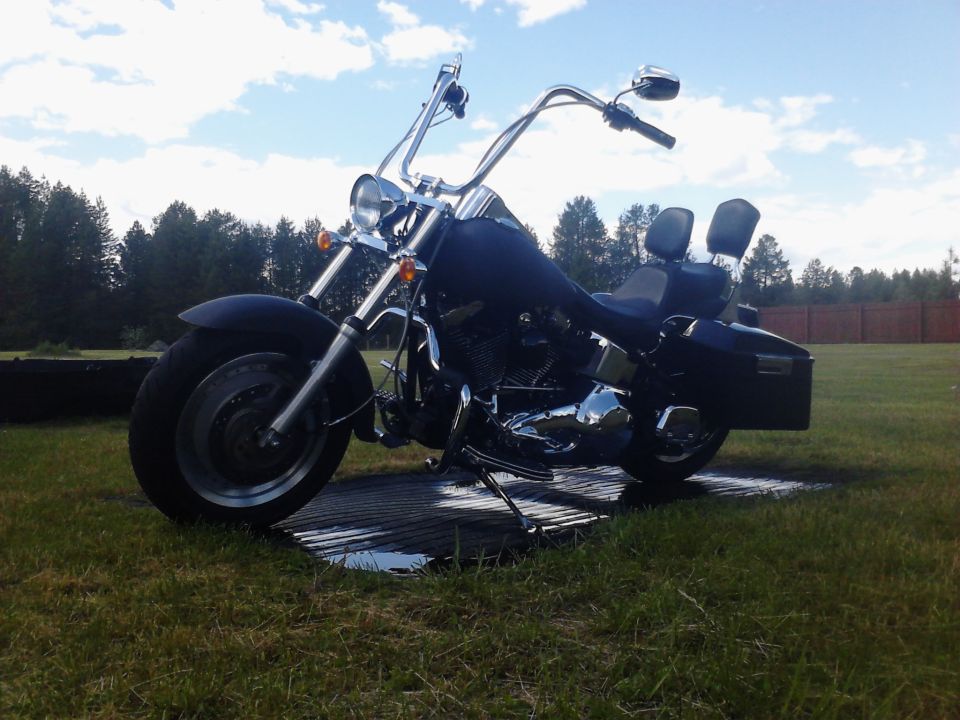 Black motorcycle with chrome handlebars and dual seats, 2000 Harley-Davidson Softail