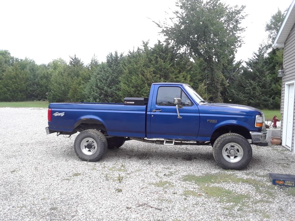 Blue 1996 Ford F-350 pickup truck, side view