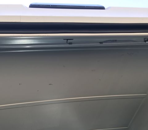 1995 Ford Bronco - Interior detail shot of a vehicle, focusing on the roof and door panel area.