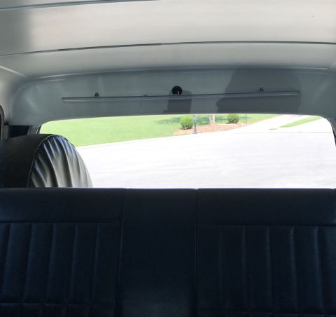 1995 Ford Bronco - Interior view of a vehicle, showing the rear seat and a spare tire cover.