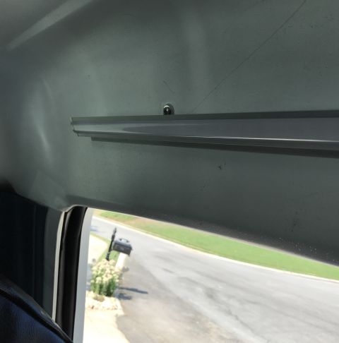 1995 Ford Bronco - View from inside a vehicle, looking out the window at a residential street.