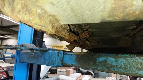 1999 Ford Fairlane - The vehicle's undercarriage is heavily corroded and appears to be structurally compromised.