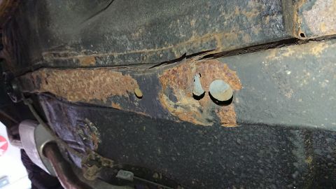 1999 Ford Fairlane - The undercarriage frame shows extensive rust, indicating structural compromise.