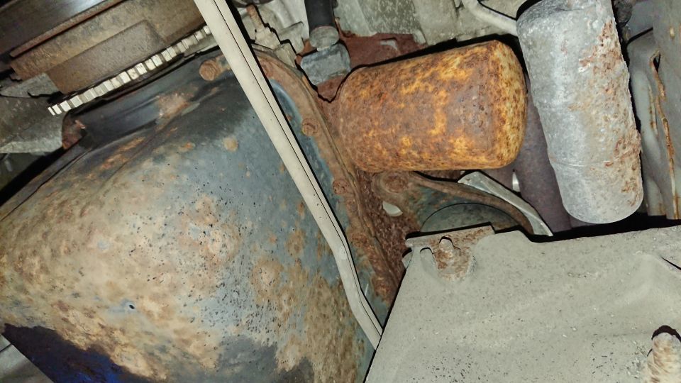 rusted exhaust pipe and undercarriage components
