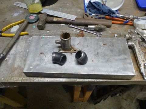 1969 MINI Cooper - Various automotive parts and tools are laid out on a workbench, ready for assembly or after modification.