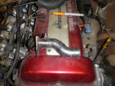 1969 MINI Cooper - Custom exhaust pipe fitting on a red engine cover with 'TWIN CAM 16V' text.