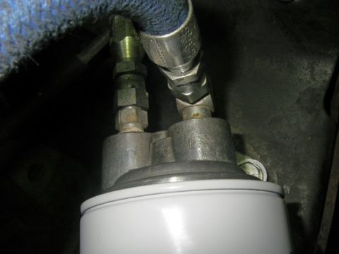 1994 Ford Bronco - Close-up of an oil filter with connected hoses, showing SUPERMOTORS branding.