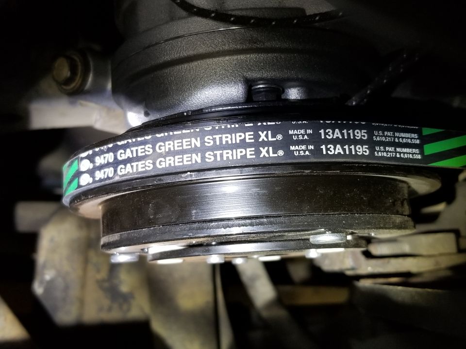 Gates Green Stripe XL serpentine belt with part number 13A1195 on a pulley