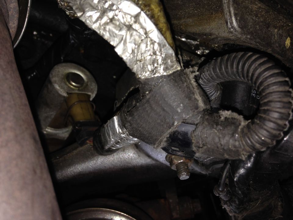 Engine hose with frayed insulation and coiled wiring