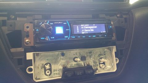 2006 Mitsubishi Evolution - Interior view of a car's dashboard with the stereo and climate controls disassembled.