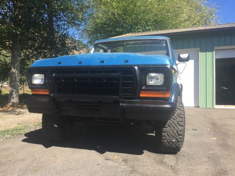 1979 Ford Bronco - 1979 Ford Bronco front end with black grille and orange accents.