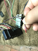 1988 Ford Bronco - Close-up of a vehicle's electrical wiring harness being worked on.