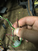 1988 Ford Bronco - Close-up of a hand holding a bundle of vehicle wires and an electrical connector.