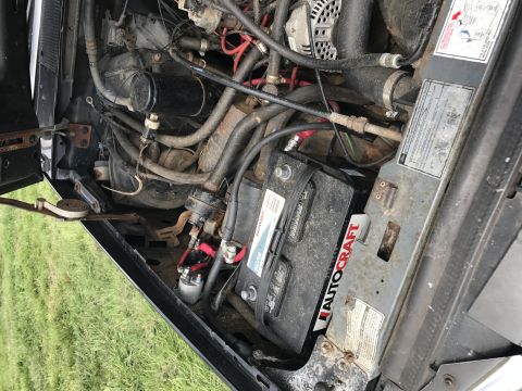 1992 Ford Bronco - Close-up of vehicle engine bay components including battery and wiring.