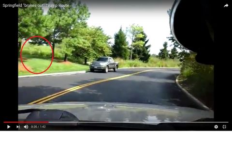 1995 Mercury Grand Marquis - A silver pickup truck is seen driving on a road, with a red circle highlighting an area of grass and trees.