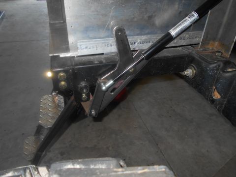 1992 Ford Bronco - Close-up view of a tailgate support strut and latch mechanism.