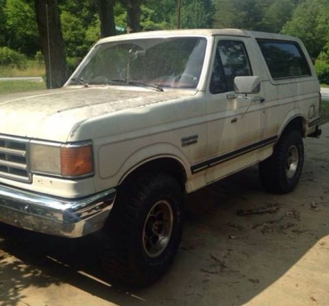 1988 Ford Bronco - This 1988 Ford Bronco is shown in a 3/4 front view, parked outdoors.