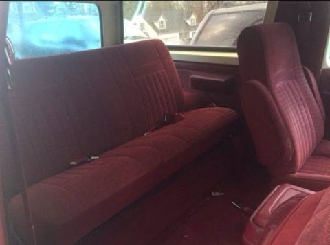 1988 Ford Bronco - Interior view of a 1988 Ford Bronco, its red upholstery and seating arrangement.