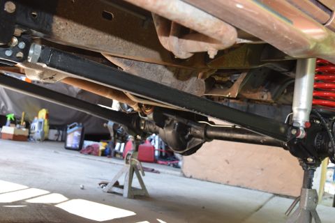 1995 Ford Bronco - Close-up of the undercarriage, focusing on suspension and drivetrain parts.
