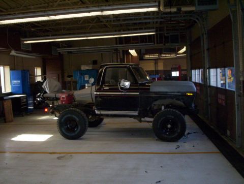1978 Ford Bronco - Ford truck chassis with cab, undergoing modification in a workshop.