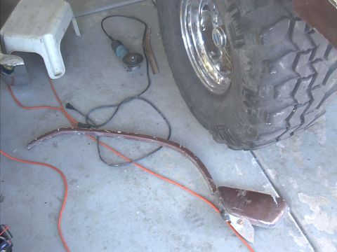 1979 Ford Bronco - Working on a vehicle part with tools and equipment nearby.