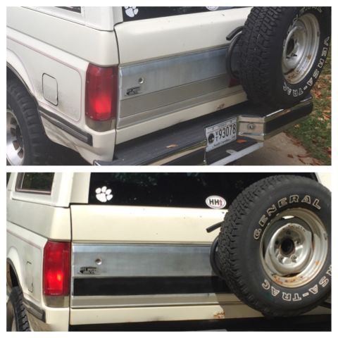1988 Ford Bronco - Rear view of a white Ford Bronco, showing a spare tire mounted on the back and a South Carolina license plate.