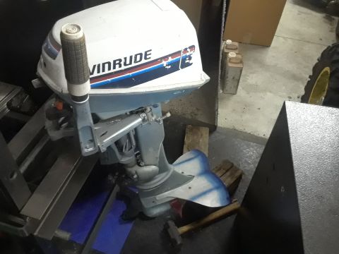 1994 Ford Bronco - An Evinrude outboard motor is shown, the brand name in prominent lettering on its white casing.