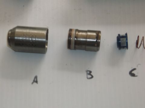 1979 Ford Ranchero - Disassembled engine valve components are laid out on a white surface, labeled A, B, and C.