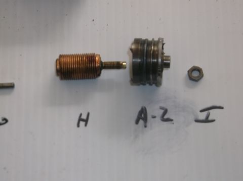 1979 Ford Ranchero - A disassembled carburetor part, labeled H, A-Z, and I, is laid out on a white surface.