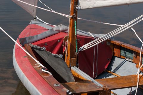 1993 Ford Bronco - Close-up view of the interior of a red and silver sailboat, showing the mast, rigging, and seating.