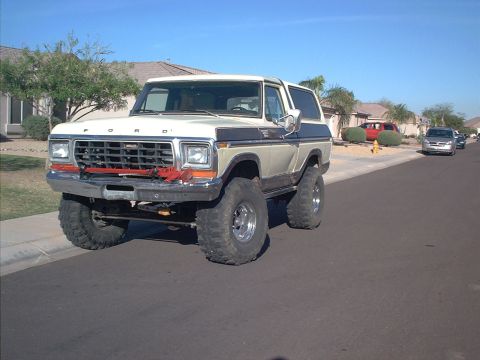 1979 Ford Bronco - This lifted Ford Bronco, likely a 1978 model, is parked on a residential street.