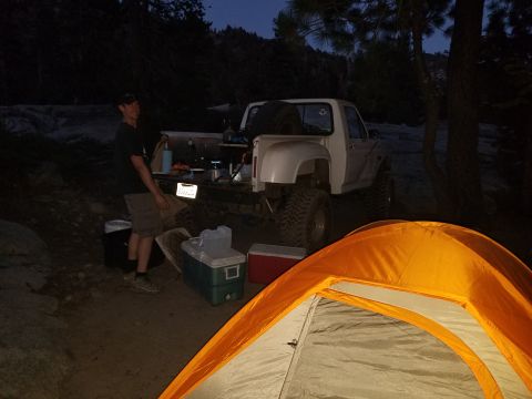 1968 Ford Bronco - Campsite scene with a pickup truck and camping equipment set up at dusk.