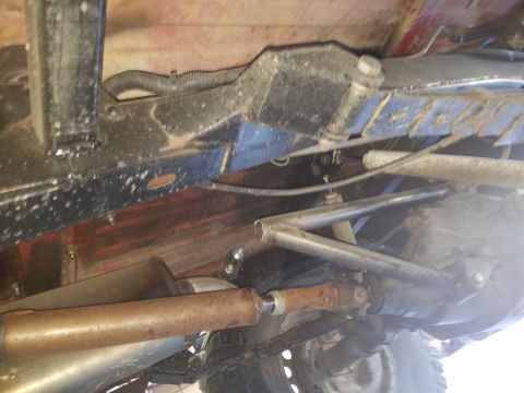 1968 Ford Bronco - Underside view of a vehicle's drivetrain, showing the exhaust system, driveshaft, and differential. The frame and suspension components are…