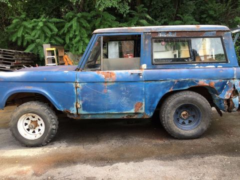 1967 Ford Bronco - This weathered blue SUV sits parked outdoors, showing signs of age and wear.