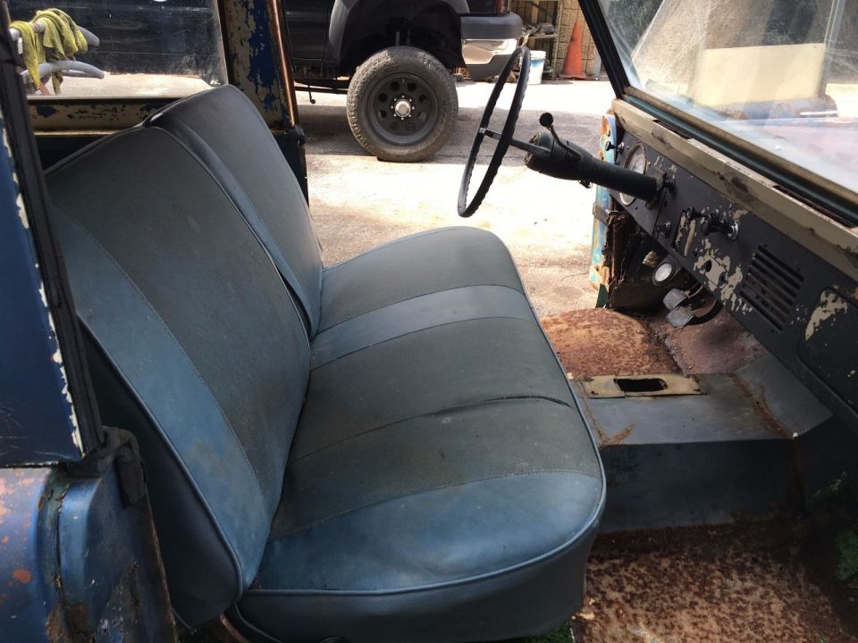 Vehicle interior with gray seats, dashboard, and steering wheel visible