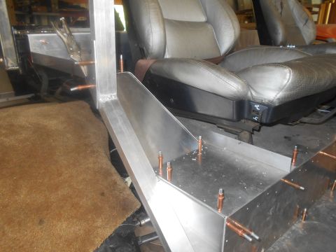 1992 Ford Bronco - Close-up view of aluminum fabrication work inside a vehicle, with two leather car seats visible in the background. The focus is on the meta…