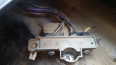 1981 Ford Bronco - A close-up view of a dusty electrical component with multiple wires connected to it. The component appears to be part of a vehicle's wiring…