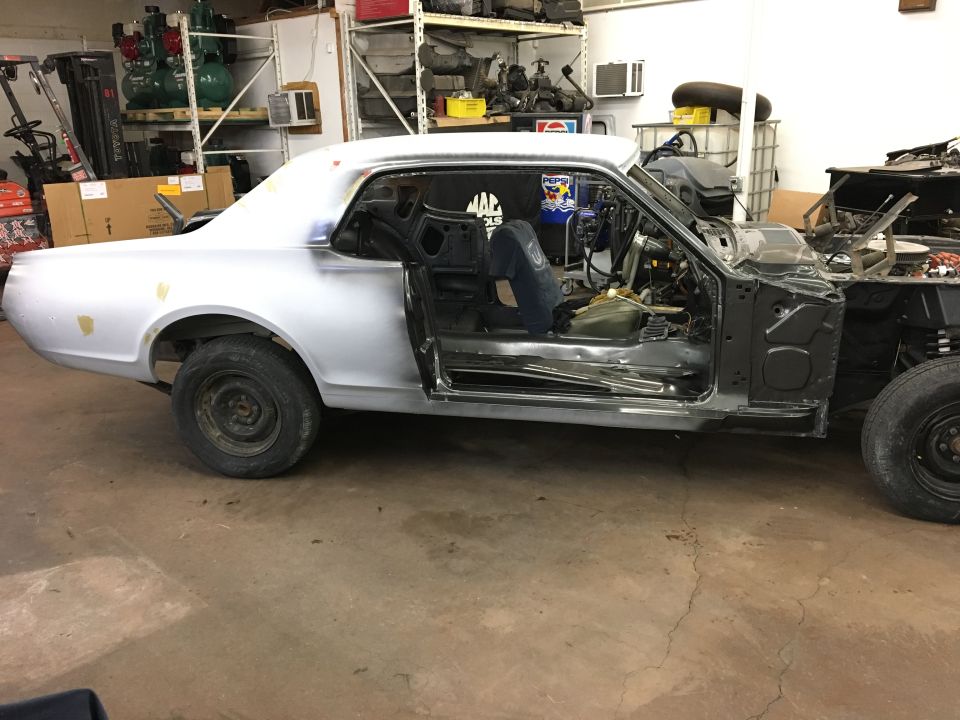 1968 Mercury Cougar undergoing restoration in a garage.