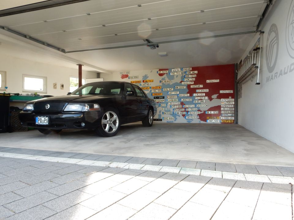 Black 2003 Mercury Marauder parked in garage with map mural