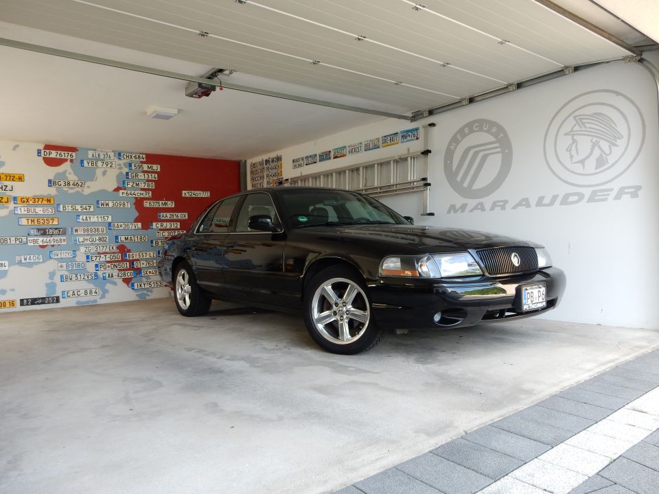 Black 2003 Mercury Marauder parked in a garage with a license plate reading PB-P9