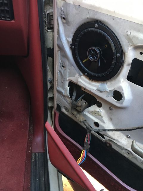 1988 Ford Bronco - The interior of a car door is exposed, revealing a speaker and its wiring harness.