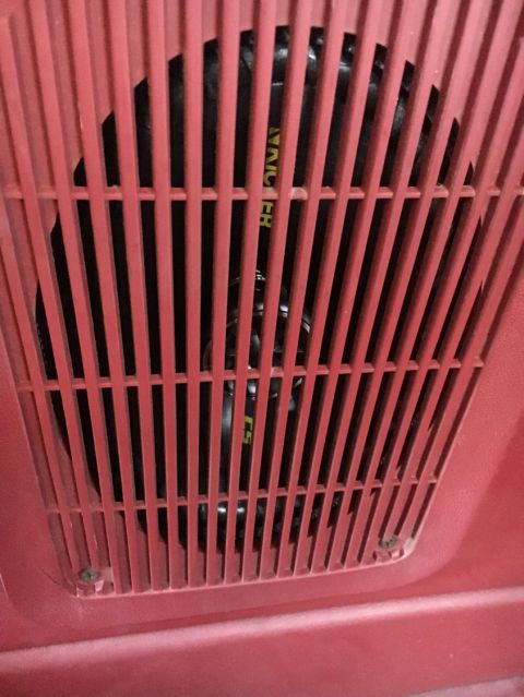 1988 Ford Bronco - Close-up of a red speaker grille with visible text on the speaker.