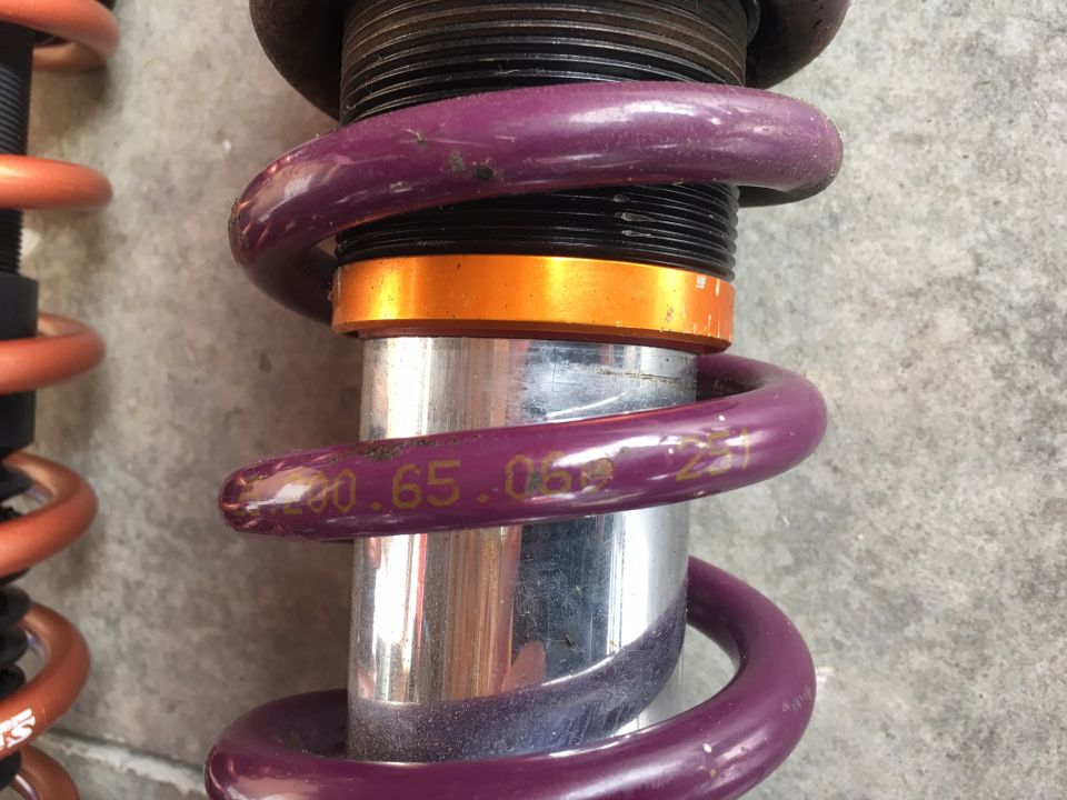 Purple coilover suspension with visible markings '200.65.05'