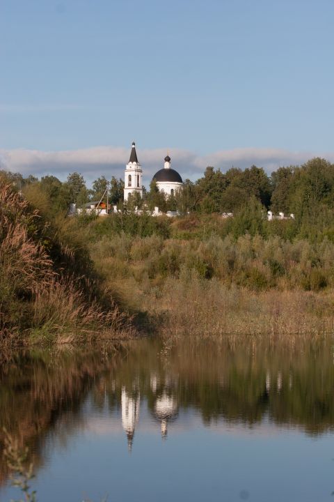 1993 Ford Bronco - A church and its reflection are visible across a river on a clear day.
