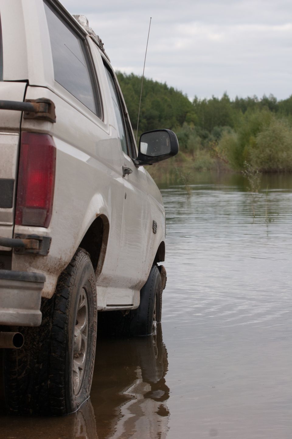 White 1993 Ford Bronco side view, partially submerged in water